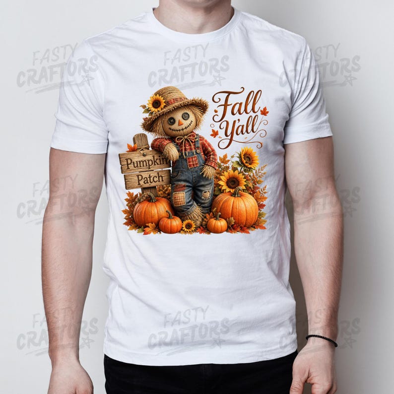May include: A white short-sleeved t-shirt featuring a graphic of a scarecrow wearing a straw hat and plaid shirt, standing by a wooden sign that reads Pumpkin Patch. The text Fall Y'all is printed above, surrounded by orange pumpkins and sunflowers.