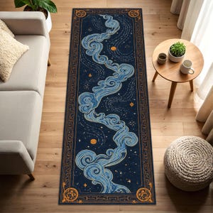 May include: A rectangular navy blue rug with a celestial design. The rug features a flowing blue cloud-like pattern with gold accents, stars, and moons. A gold border with geometric patterns frames the design. This rug is suitable for a hallway or entryway.