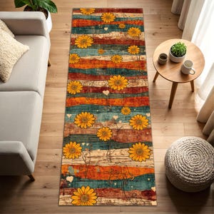 May include: A rectangular runner rug with a distressed wood-look design. The rug features horizontal stripes in shades of teal, orange, and brown, adorned with yellow sunflowers and small white hearts. The rug is designed for indoor use.