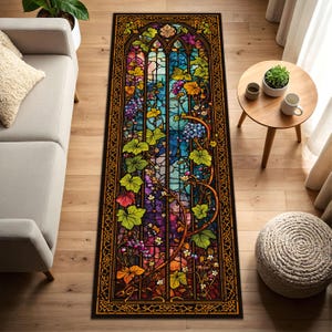 May include: A rectangular rug with a stained-glass window design. The rug features a vibrant array of colors, including blue, purple, green, and yellow. The design includes grape vines, leaves, and floral elements, framed by a dark border.