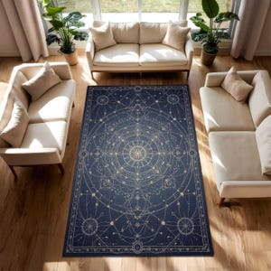 May include: A navy blue rectangular rug with a celestial design, featuring a central compass rose and star patterns. The rug has a cream-coloured border and design elements. It's placed on a wooden floor in a living room setting, with cream-coloured sofas.