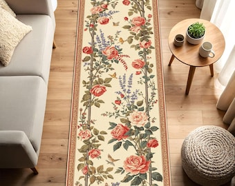 May include: A rectangular rug with a cream background and a floral design. The rug features a trellis with climbing roses in shades of red and pink, along with lavender and butterflies. The border is a reddish-brown color.