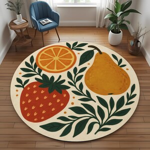 May include: A round rug featuring a fruit design. The rug has a cream background with illustrations of an orange slice, a strawberry, and a pear. Green leaves and dots surround the fruit. The rug is a decorative floor covering.
