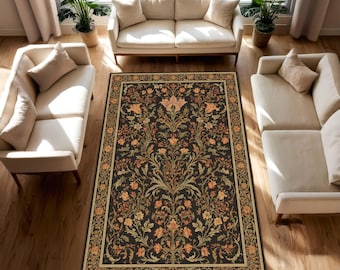 May include: A rectangular area rug with a dark background and a floral pattern in shades of orange, gold, and green. The rug has a detailed border and is placed in a living room setting with cream-colored sofas and plants.