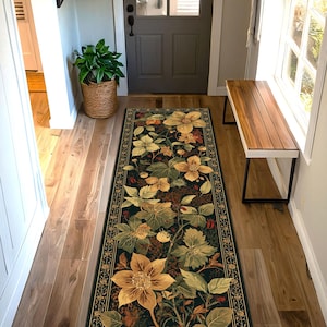 May include: A long, rectangular floral rug with a dark background and a detailed botanical design. The rug features large, stylized yellow and green flowers, leaves, and berries. A decorative border frames the floral pattern, adding a touch of elegance to the hallway.