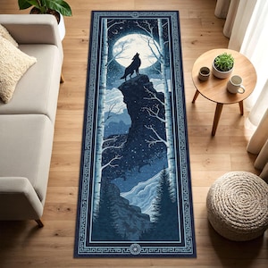 May include: A rectangular rug featuring a nighttime forest scene with a howling wolf on a cliff under a full moon. The rug has a dark blue border with a geometric pattern and a detailed illustration of trees and mountains.