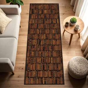 May include: A rectangular area rug with a repeating pattern of vintage books in shades of brown, tan, and blue. The rug has a dark border and is placed on a hardwood floor. The rug is a decorative element for a living room.