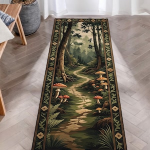 May include: A rectangular rug featuring a forest scene with a winding path, trees, and mushrooms. The rug has a dark green border with floral and leaf patterns. The central design showcases a detailed landscape with a stone path.