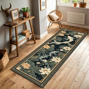 May include: A rectangular rug with a koi carp design swimming amongst lotus flowers and lily pads. The rug has a dark teal background with cream-coloured flowers and a decorative border. The rug is approximately 91 cm wide and 244 cm long.