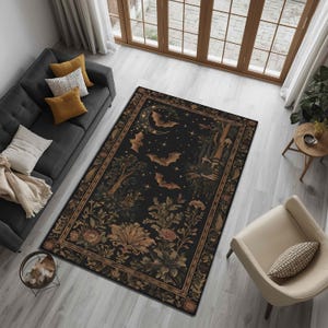 May include: A rectangular area rug with a dark background featuring bats, stars, and floral elements. The rug has a detailed border and is placed in a living room setting with a sofa and chair.