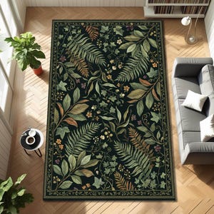May include: Rectangular rug with a dark background and a botanical design. The rug features a detailed pattern of green, brown, and yellow leaves, ferns, and flowers. A thin border frames the design. The rug is placed on a wooden floor.