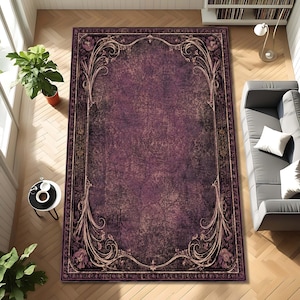 May include: A rectangular area rug featuring a deep purple, distressed center with a dark, ornate border. The border displays intricate, swirling floral patterns in muted tones, framing the central field with a classic, symmetrical design.