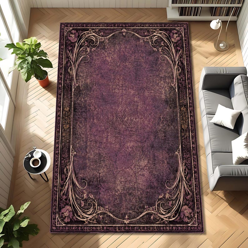 May include: A rectangular area rug featuring a deep purple, distressed center with a dark, ornate border. The border displays intricate, swirling floral patterns in muted tones, framing the central field with a classic, symmetrical design.