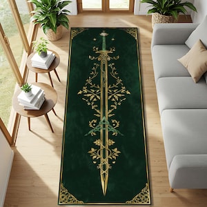 May include: A rectangular green rug with a gold sword design. The sword is vertical, with intricate gold floral patterns and a triangular emblem. The rug has a gold border and is placed on a wooden floor.