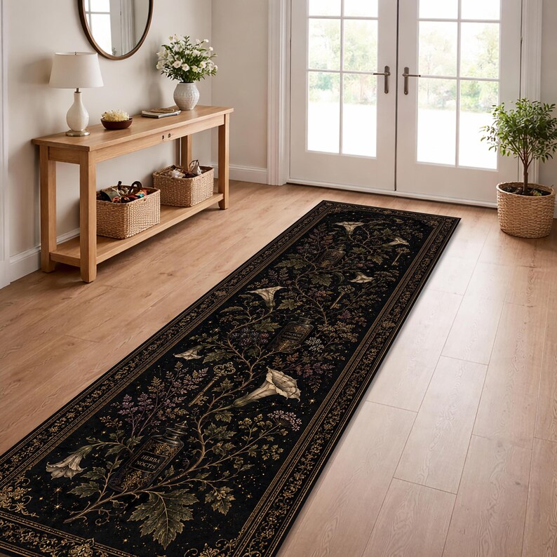 May include: A long rectangular runner rug featuring a black background with a botanical pattern of white trumpet-shaped flowers, green leaves, and small apothecary bottles labeled Herba Noctis, all framed by a decorative gold-toned border.