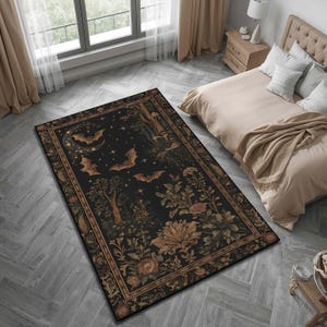 May include: A rectangular black rug with a detailed design featuring bats, a crescent moon, stars, trees, and floral elements. The rug has a decorative border in shades of brown and gold, creating a gothic or Halloween theme.