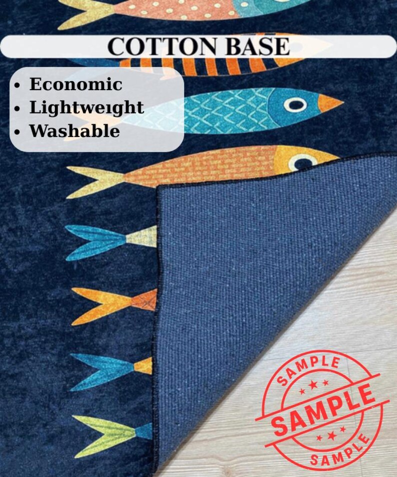 May include: A navy blue rug with a fish pattern in orange, blue, and yellow. The rug has a cotton base and is described as economic, lightweight, and washable. The word "SAMPLE" is stamped on the rug.