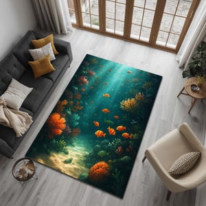May include: A rectangular area rug featuring an underwater scene with orange and yellow coral, schools of orange fish, and a sandy seabed. The rug has a teal and blue background, creating a vibrant and immersive design.