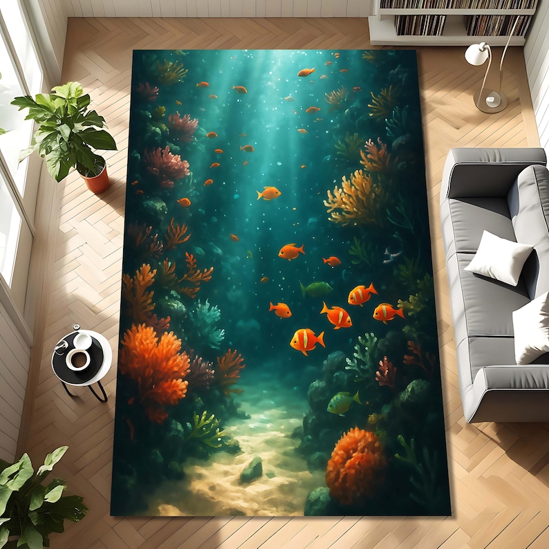 May include: A rectangular area rug featuring an underwater scene with orange fish, coral, and a sandy seabed. The rug's design includes shades of blue, green, and orange, creating a vibrant and immersive aquatic environment.