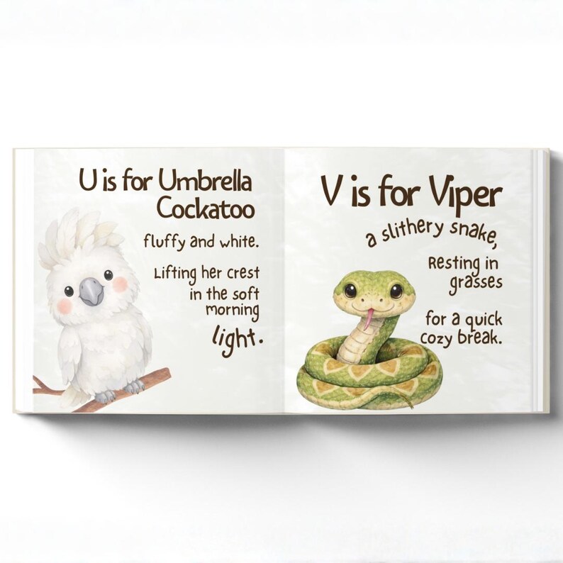 May include: An open children's book showing a white cockatoo and a green viper. The text reads "U is for Umbrella Cockatoo" and "V is for Viper". The illustrations are in a watercolour style.