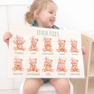 May include: A white ceramic mug with a black handle and the text "But First, Coffee" in a black, handwritten-style font. The mug is on a white surface.