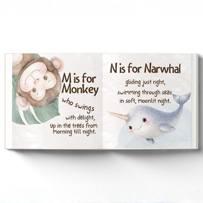 May include: An illustrated children's book open to two pages. One page features a monkey and the text "M is for Monkey". The other page shows a narwhal with the text "N is for Narwhal". The illustrations are colourful and the text is easy to read.