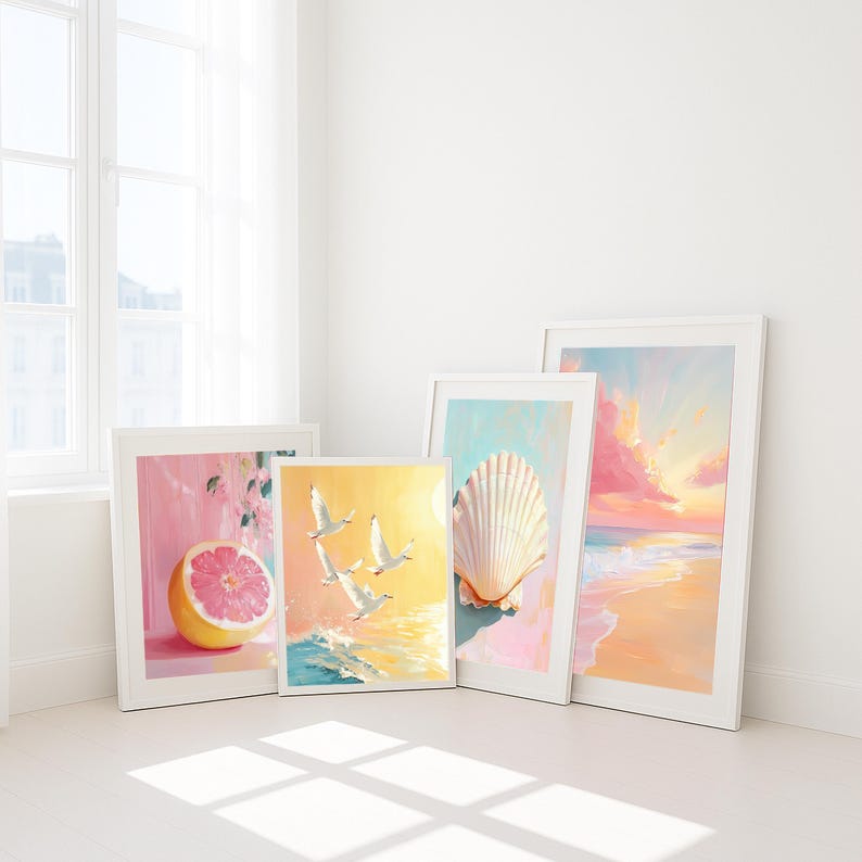 May include: Four framed art prints with white frames. The prints depict a grapefruit, seagulls over the ocean, a seashell, and a beach scene. The artwork features pastel colors of pink, yellow, and blue, creating a serene and coastal theme.