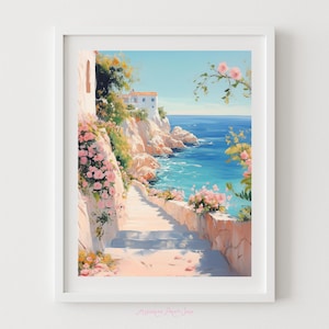 May include: A framed watercolor print depicts a coastal scene with a stone staircase leading down to the sea. Pink flowers and lush greenery adorn the walls. A white building sits atop a cliff, overlooking the turquoise water.
