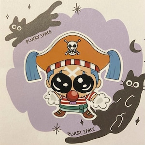 May include: A sticker featuring a cartoon pirate clown with a red nose, wearing a pirate hat with a skull and crossbones. The sticker has the text "PLUCKY SPACE" and includes black cat illustrations and stars.