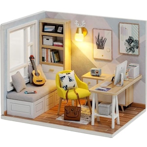 May include: Miniature dollhouse room with a window, a guitar, a yellow chair, and a desk with a computer. The room has a bookshelf, artwork, and a small radio. A brown leather bag sits on the floor.