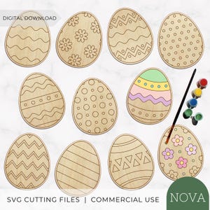 May include: A collection of eleven egg-shaped wooden cutouts featuring various engraved patterns including waves, flowers, dots, and zigzags. One egg is partially painted in pastel colors, accompanied by a small paintbrush and paint pots.
