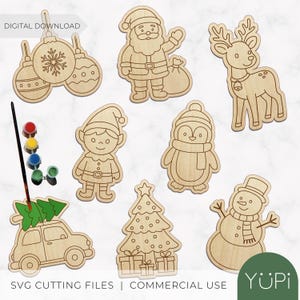 May include: A selection of unpainted wooden Christmas decorations, featuring Santa Claus, a reindeer, a snowman, and a Christmas tree. The image also includes paint and a paintbrush, indicating a DIY craft project. The text "DIGITAL DOWNLOAD" and "SVG CUTTING FILES | COMMERCIAL USE" are visible.