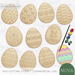 May include: A set of ten wooden egg-shaped cutouts featuring various engraved patterns including polka dots, bunny faces, flowers, bows, and geometric lines. One egg is partially painted with pastel wavy stripes, accompanied by a paintbrush and paint pots.