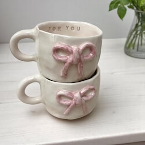Handmade Beige Ceramic Mug with Bow Detail – Unique Pottery Coffee Cup – 200ml – Food Safe & Heat Resistant – Cute Gift Idea