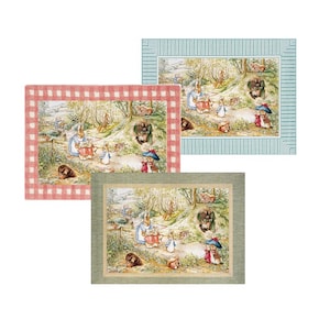 May include: Three different framed images of a Peter Rabbit themed illustration. The images are framed in red and white gingham, green, and blue. The illustration shows Peter Rabbit and other rabbits in a forest setting.