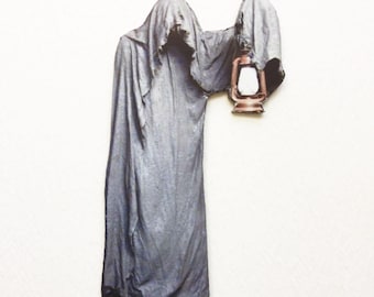 May include: A gray ghost figure with a long, flowing robe and a hood pulled over its head. The ghost is holding a lantern in its right hand.