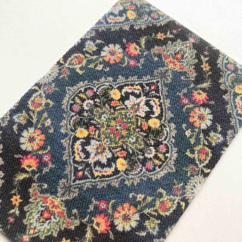 May include: A blue rug with a floral pattern in shades of yellow, red, and white. The rug has a central medallion with a geometric design.
