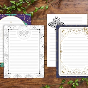 May include: A selection of lined stationery featuring moth and celestial designs. The stationery has various colour schemes, including purple, navy, and white, with gold and black accents. The designs include moons, stars, and geometric patterns.