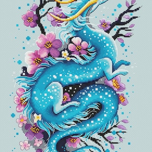 May include: A cross-stitch design of a blue dragon with yellow horns and accents, encircled by purple and pink flowers and black branches. The dragon is in a dynamic pose, set against a light blue backdrop. The artist's name is in the bottom right corner.