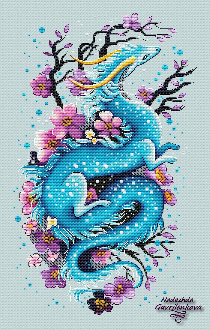 May include: A cross-stitch design of a blue dragon with yellow horns and accents, encircled by purple and pink flowers and black branches. The dragon is in a dynamic pose, set against a light blue backdrop. The artist's name is in the bottom right corner.