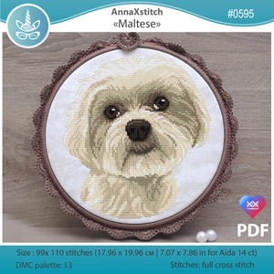 May include: A cross-stitch of a Maltese dog in a round frame. The dog has light beige fur and dark eyes. The frame is brown with a decorative edge. The text "AnnaXstitch Maltese" is at the top. The size is 17.96 x 19.96 cm.