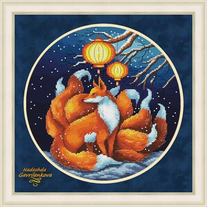 May include: A framed cross-stitch embroidery featuring a nine-tailed orange fox with white accents, set against a dark blue night sky with falling snow, two glowing yellow lanterns, and tree branches. The text Nadezhda Gavrilenkova is visible.