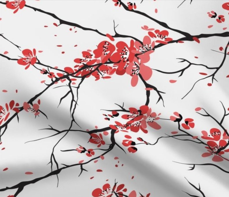 May include: A white background with black branches and red cherry blossoms. The branches are thin and delicate, and the blossoms are clustered together in groups of three or four.
