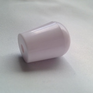 May include: White plastic knob with a smooth, rounded surface. The knob has a small hole in the center.