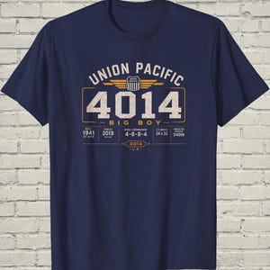 May include: A navy blue t-shirt featuring a graphic print of the Union Pacific 4014 Big Boy locomotive. The design includes the text Union Pacific, 4014, Big Boy, and technical specifications like built 1941, rebuilt 2019, 4-8-8-4, and 5400lb.