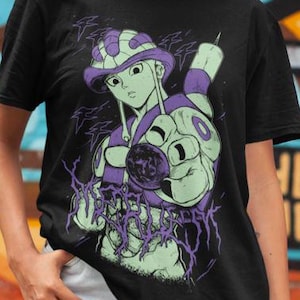 May include: Black t-shirt featuring a graphic of a character with a purple and green color scheme. The design includes the text "MERUEM" in a stylized font. The background is a colorful graffiti wall.