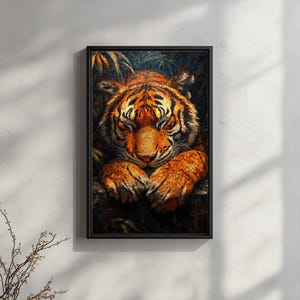 May include: A framed art print featuring a detailed illustration of a tiger resting peacefully. The tiger's orange and black fur is rendered with intricate detail, and its eyes are closed. The artwork is set against a dark, leafy background.