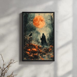 May include: A framed Halloween-themed art print. The artwork depicts a dark forest scene with a large orange moon, a cloaked figure, a crow, and pumpkins. The color palette includes orange, black, and gray tones.