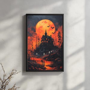 May include: A framed Halloween-themed artwork depicts a spooky mansion on a hill under a large orange moon. Silhouetted bats fly in the sky. Ghosts and trees are also visible in the dark, ominous landscape. The artwork is framed in a black frame.