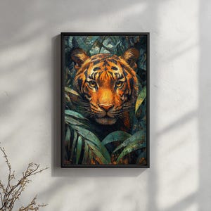 May include: A framed art print depicting a tiger's face amidst green foliage. The tiger has orange and black stripes, with intense yellow eyes. The artwork is set in a black frame, creating a striking contrast. The print evokes a jungle scene.